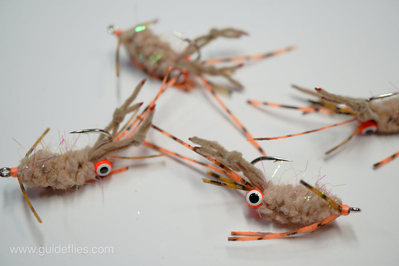 Guard Hair Chenille with contrasting rubber legs and small pearl UV micro tinsel built into a very translucent microfiber tied on Umpqua XS410 Premium Flats Hook this particular fly come with an orange bead and white black pupils
