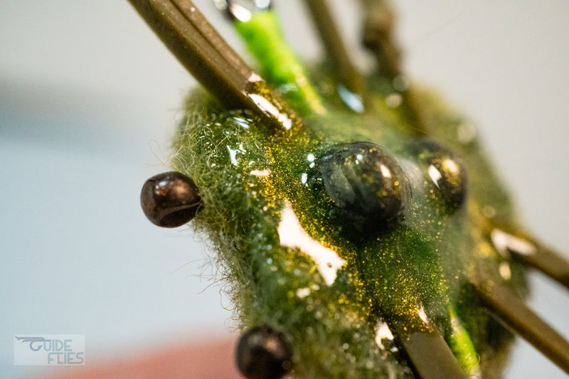 Belly of green combo crab and black beaded eyes with  matching epoxy resin