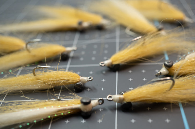 Tan and white craft fur closure minnow with weighted black eyes