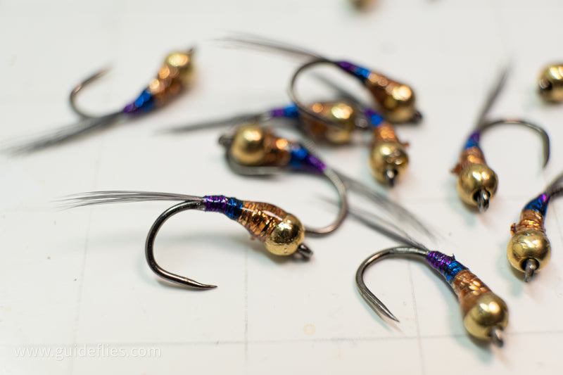 Gold Digger Perdigon Nymph with heavy gold tungsten bead and a purple blue and copper metallic body oversize comp hook