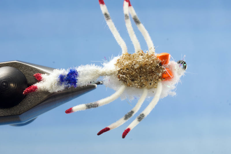 Body Guard Crab tied with white material using a Umpqua X-Series XS410 Flats hook design has a prominent claw  with a sand belly