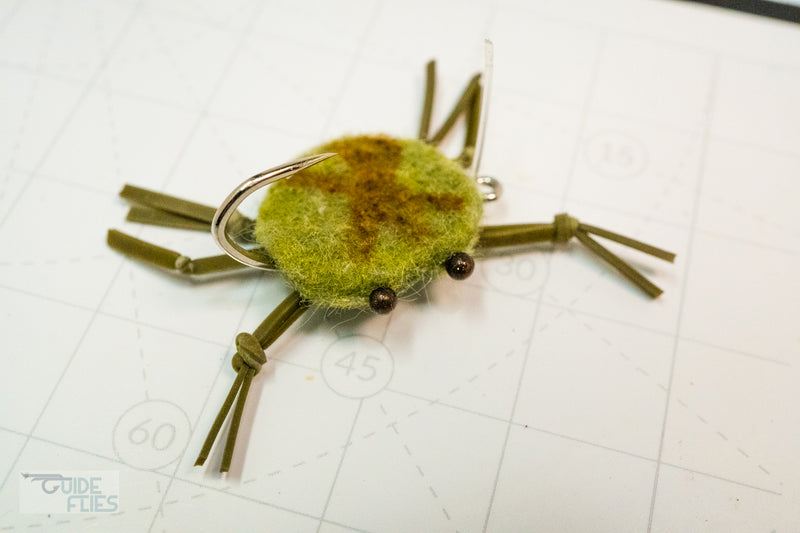 Green combo crab with brown marking on the back with rubber legs and Umpqua hooks with black beaded eyes