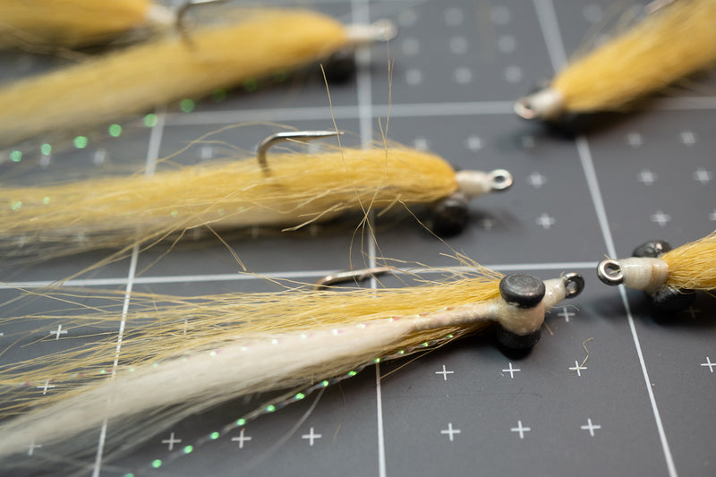 Tan and white craft fur closure minnow with weighted black eyes