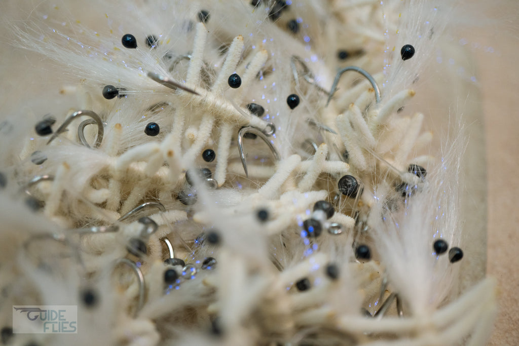 White Abaco Mantis tied with the legs of a Flexo Crab, natural Angora yarn body and Polar Fiber that blend with any bottom. A few strands of Krystal Flash add just the right amount of sparkle. Applied with small black beady eyes with a size #4 or #6 hook