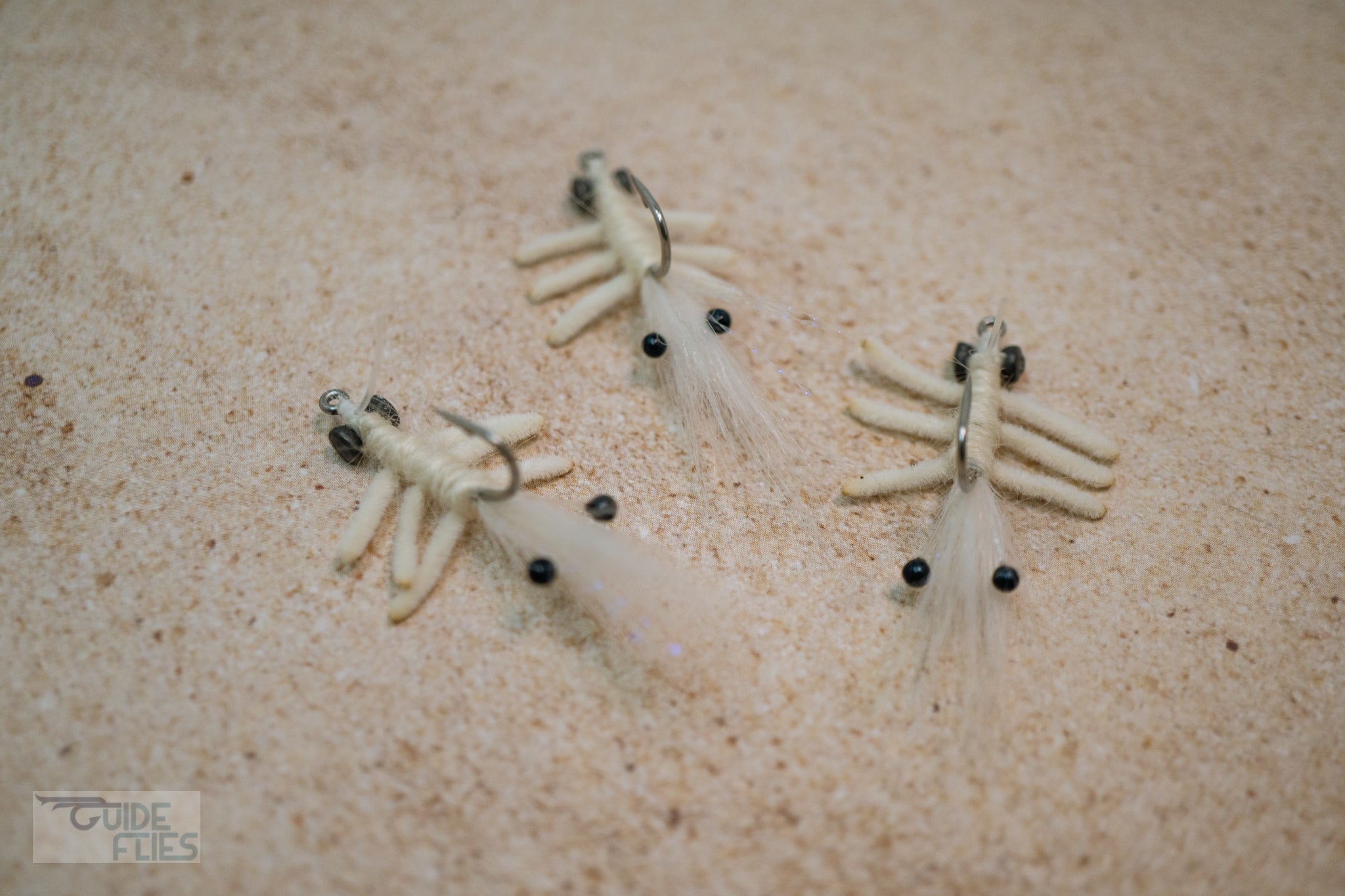 White Abaco Mantis tied with the legs of a Flexo Crab, natural Angora yarn body and Polar Fiber that blend with any bottom. A few strands of Krystal Flash add just the right amount of sparkle. Applied with small black beady eyes with a size #4 or #6 hook