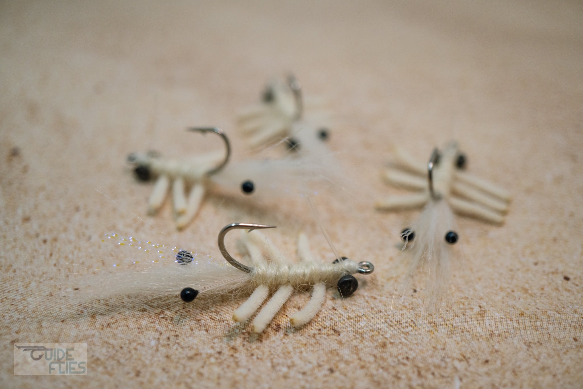 White Abaco Mantis tied with the legs of a Flexo Crab, natural Angora yarn body and Polar Fiber that blend with any bottom. A few strands of Krystal Flash add just the right amount of sparkle. Applied with small black beady eyes with a size #4 or #6 hook