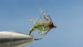 Created with Partrige soft-hackle wraps this green and brown EDC Caddis is small to carry around
