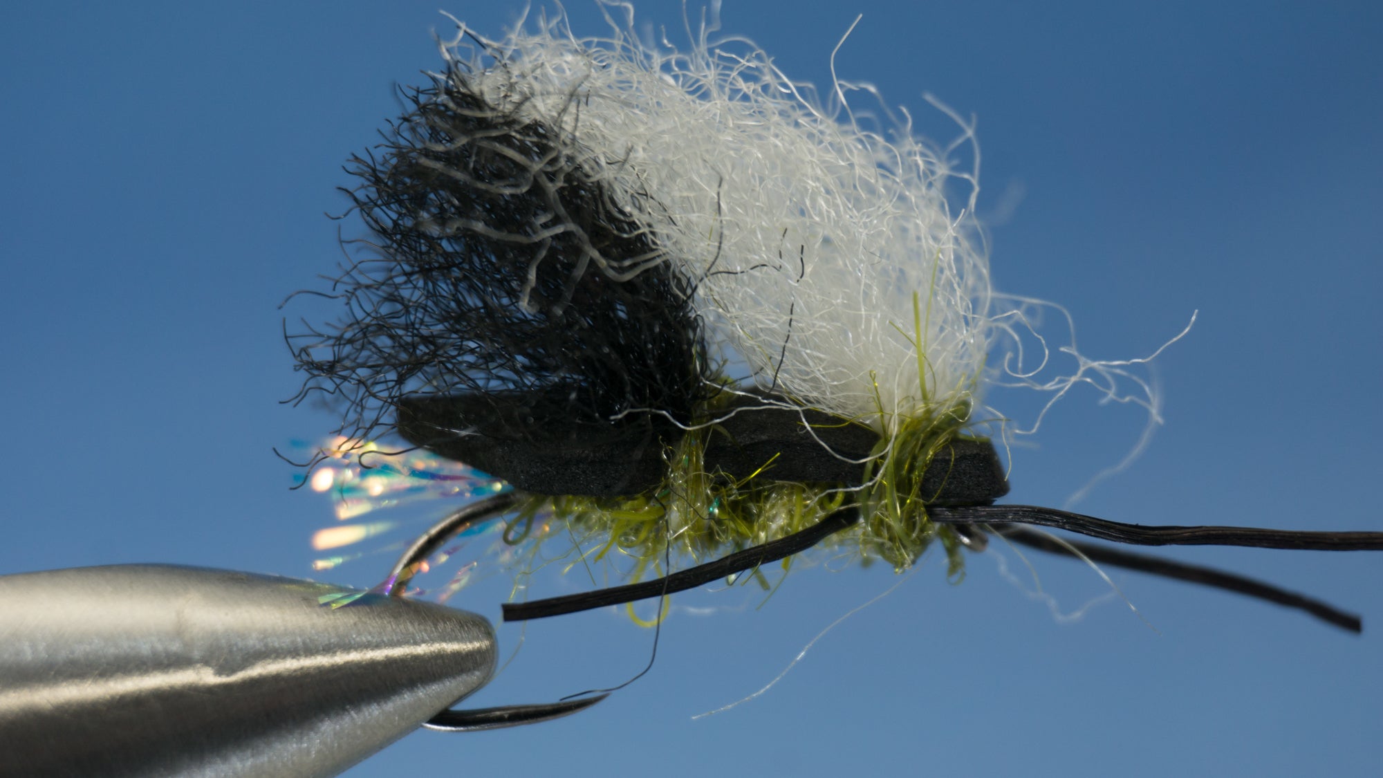 Made with 2 crinkle hair and a firehole outdoor hook colored in white, olive, and black 