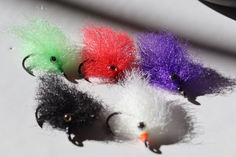 Saltwater fly of varying colors with beaded eyes with a size 1 umpqua hook that are great for catching tarpon