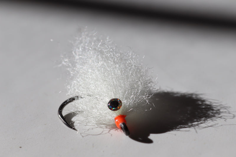 Saltwater fly of colored white with beaded eyes with a size 1 umpqua hook that are great for catching tarpon