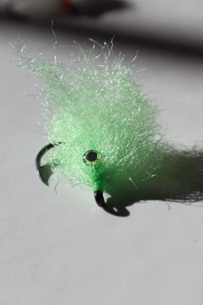 Saltwater fly of colored green with beaded eyes with a size 1 umpqua hook that are great for catching tarpon